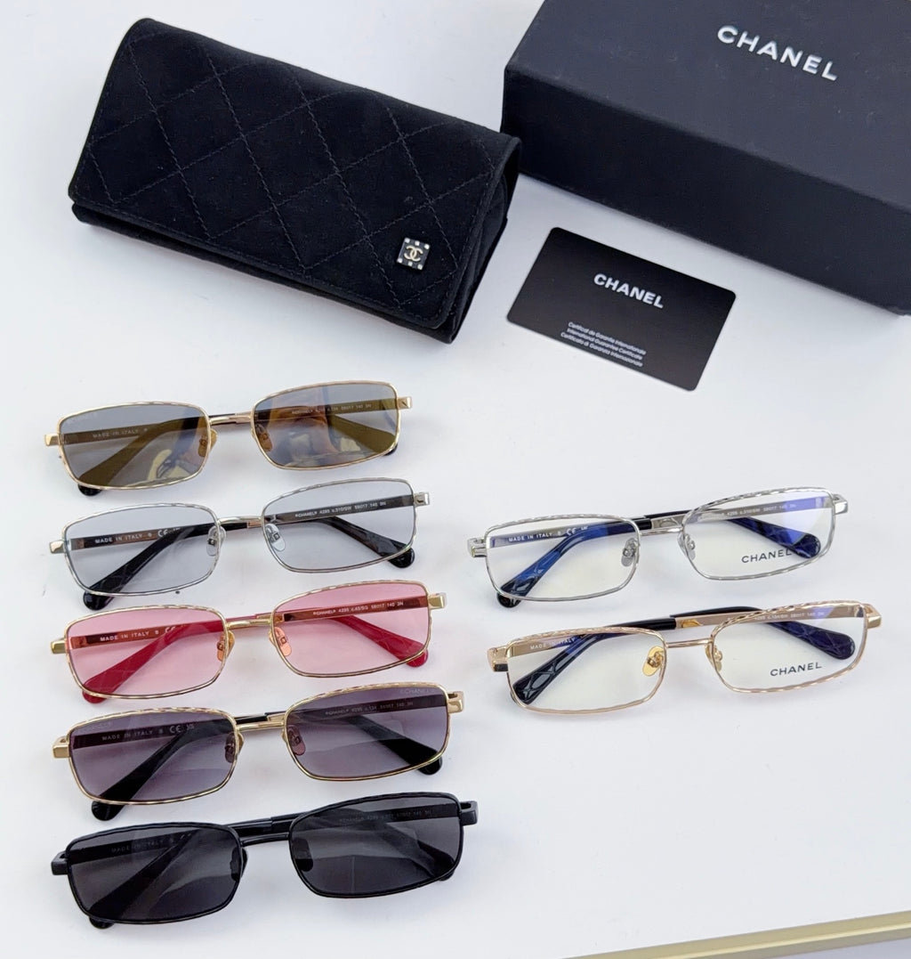 Assorted Chanel glasses with mixed frames and colored lenses, laid out together