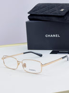 Gold Chanel glasses with light lenses and dark temple tips