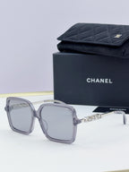 Chanel square sunglasses with light gray frame, gold-tone logo arms, pale gray lenses