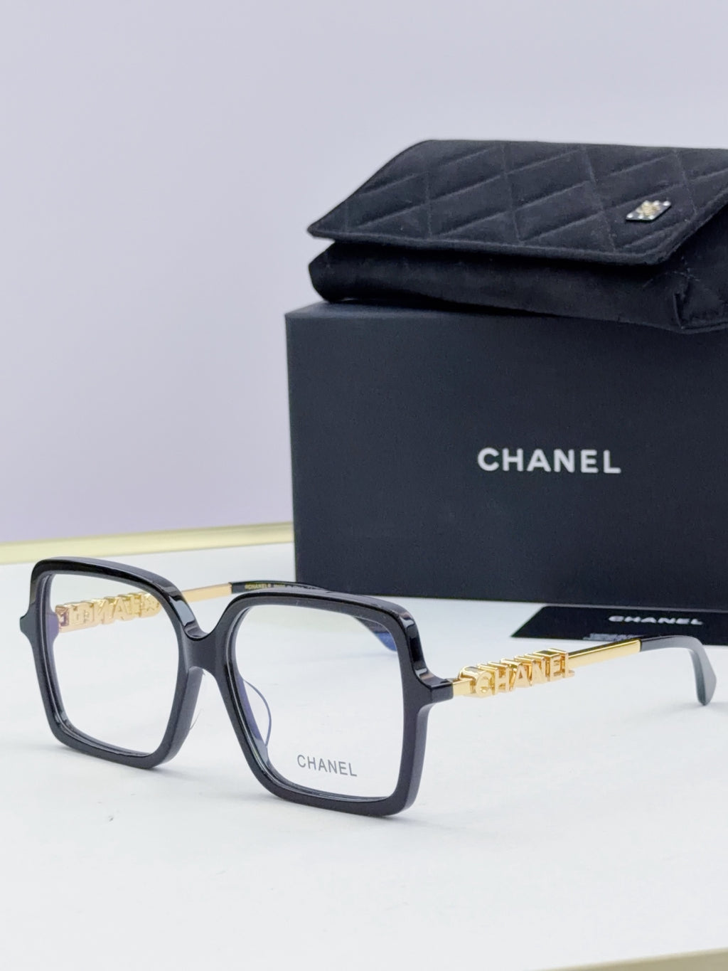 Chanel eyeglass frames, dark navy square acetate with gold logo detail, with black case