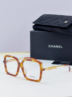 Chanel eyeglass frames, tortoiseshell square acetate with gold logo detail, with black case