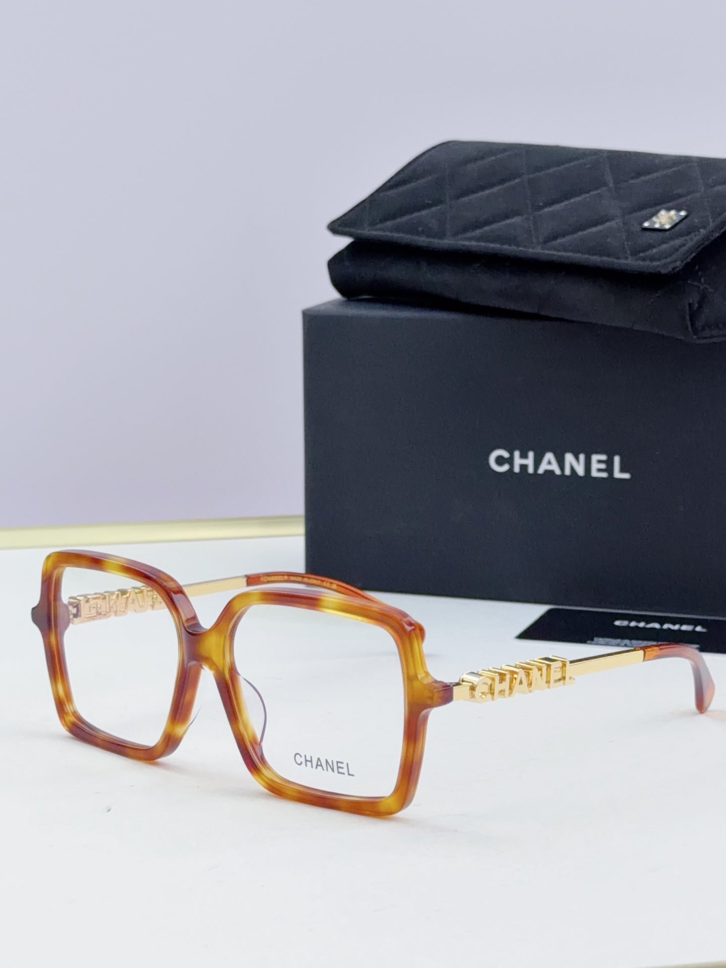 Chanel eyeglass frames, tortoiseshell square acetate with gold logo detail, with black case