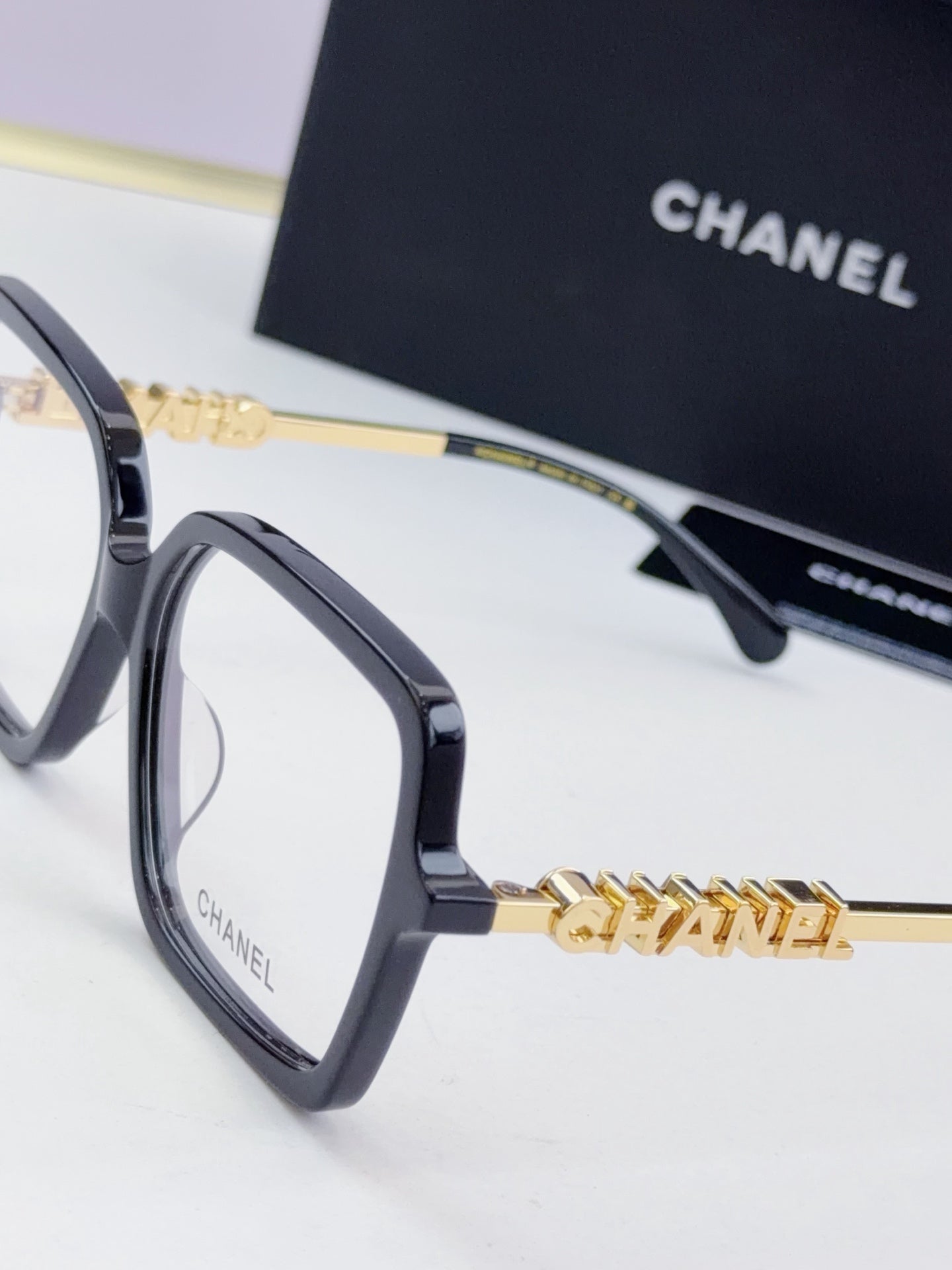 Chanel eyeglass frames, dark gray square acetate with gold logo hinge detail
