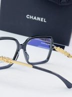 Chanel eyeglass frames, dark gray square acetate with blue lens tint and gold logo detail