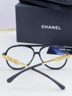 Chanel optical glasses with black round frames and gold chain front bridge