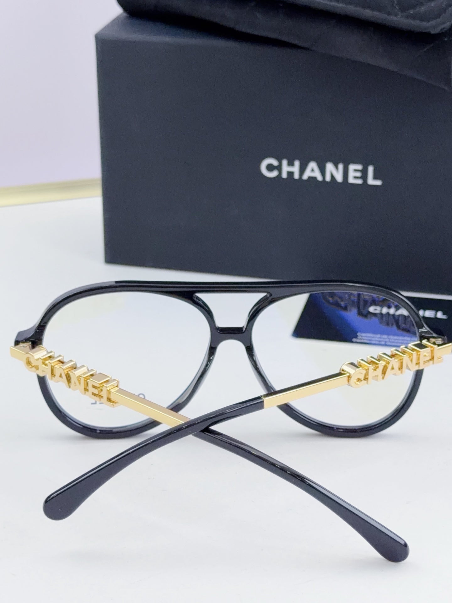 Chanel optical glasses with black round frames and gold chain front bridge
