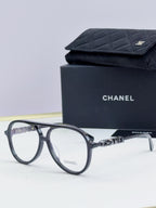 Chanel optical glasses with dark gray round frames and gold temple accents