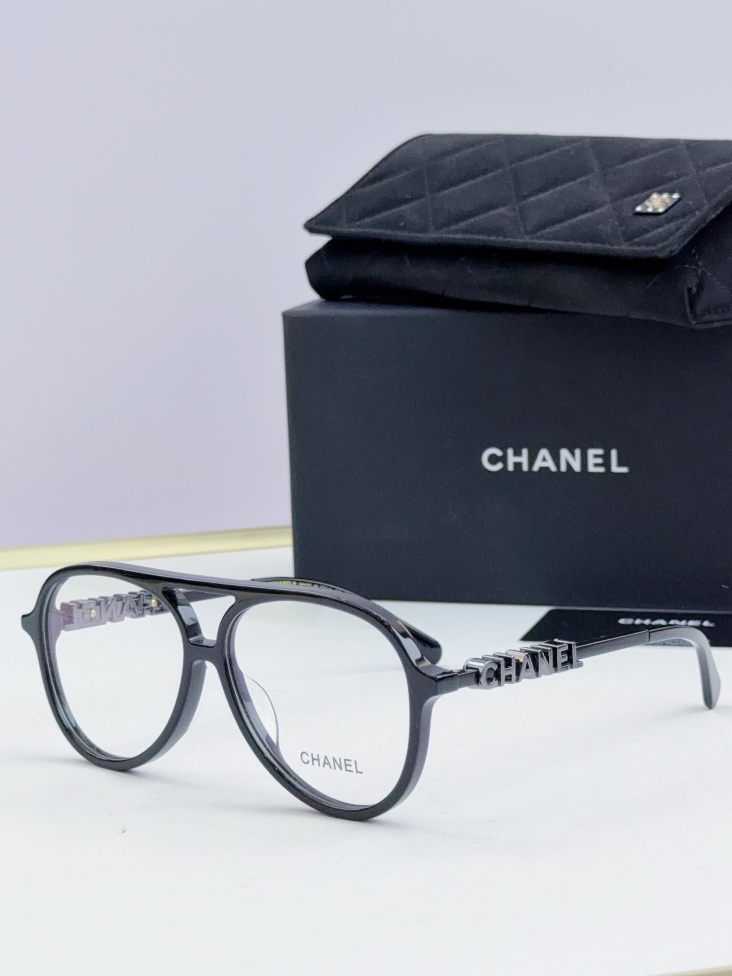 Chanel optical glasses with dark gray round frames and gold temple accents