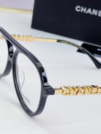 Chanel optical glasses, navy-blue frame with gold chain temple detailing
