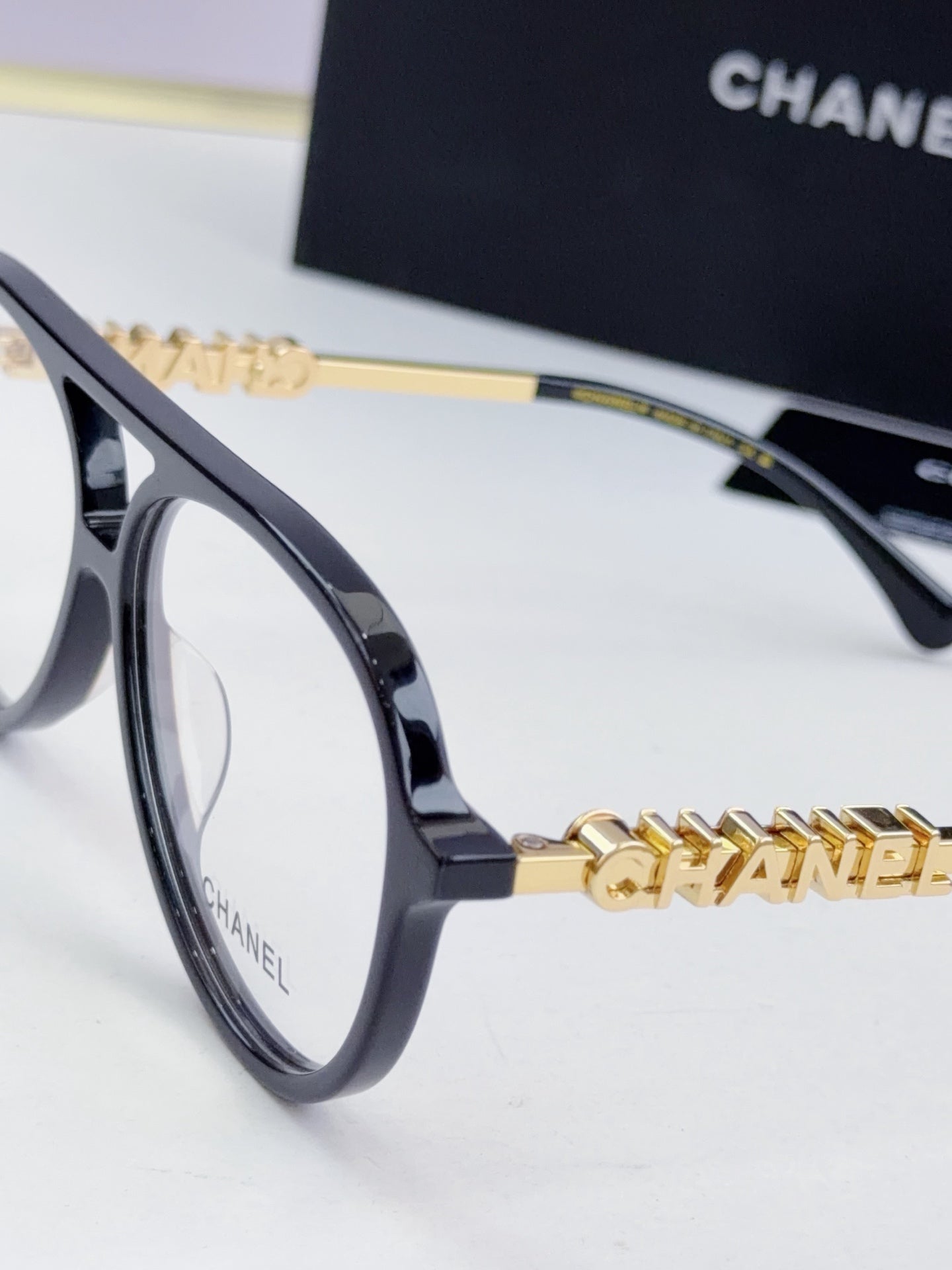 Chanel optical glasses, navy-blue frame with gold chain temple detailing