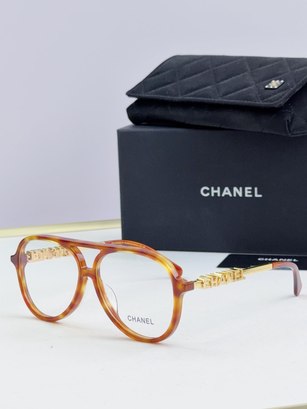 Chanel optical glasses with amber round frames and gold temple accents