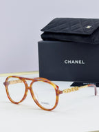 Chanel optical glasses with amber round frames and gold temple accents