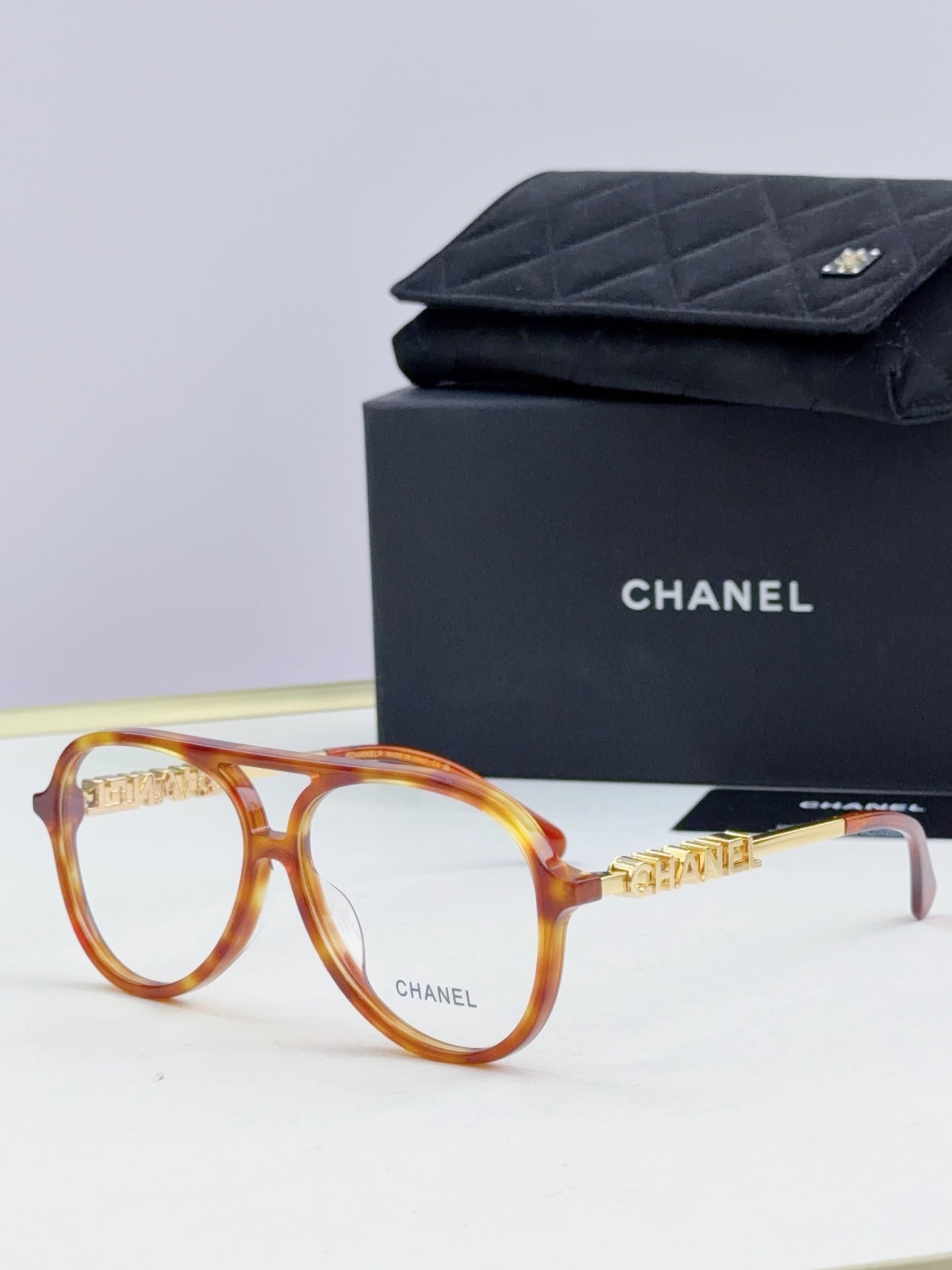 Chanel optical glasses with amber round frames and gold temple accents