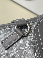 Goyard bag strap attachment with metal ring and stitched leather tab