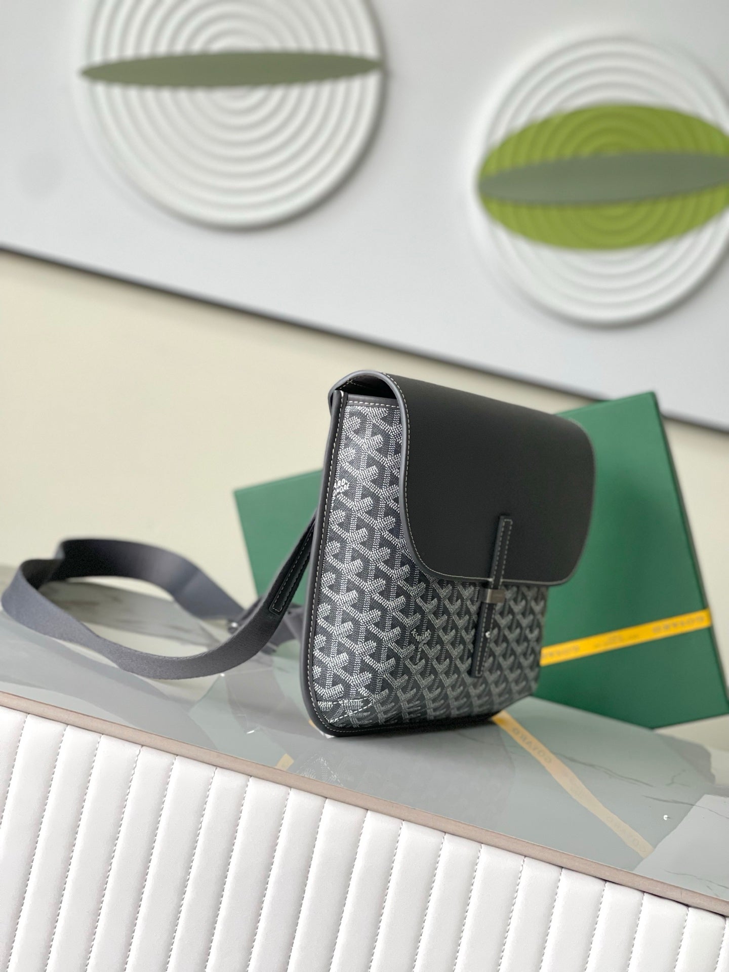 Goyard small crossbody bag with structured shape, dark flap and gray strap