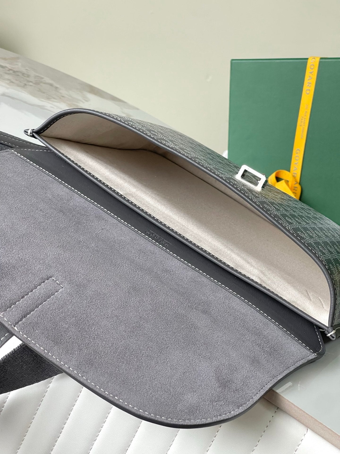 Goyard bag interior opening with gray lining and top flap edge
