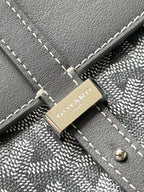 Goyard logo plaque on gray flap with stitched trim