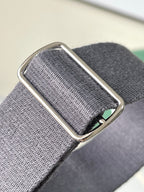 Goyard adjustable strap buckle on gray textured webbing