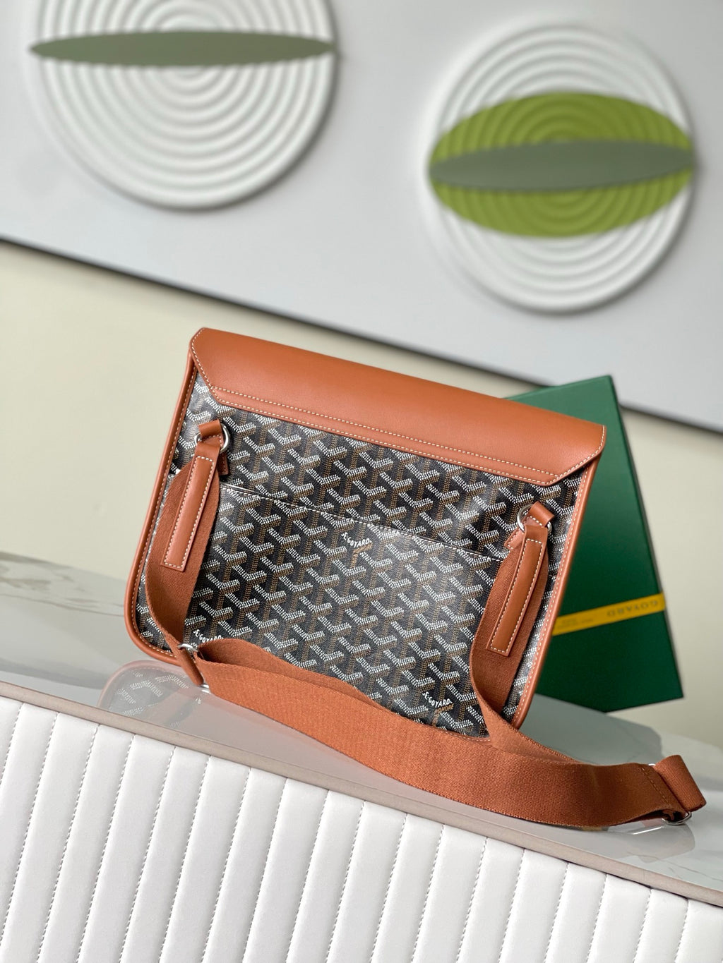 Patterned handbag with tan flap and leather trim, open top view