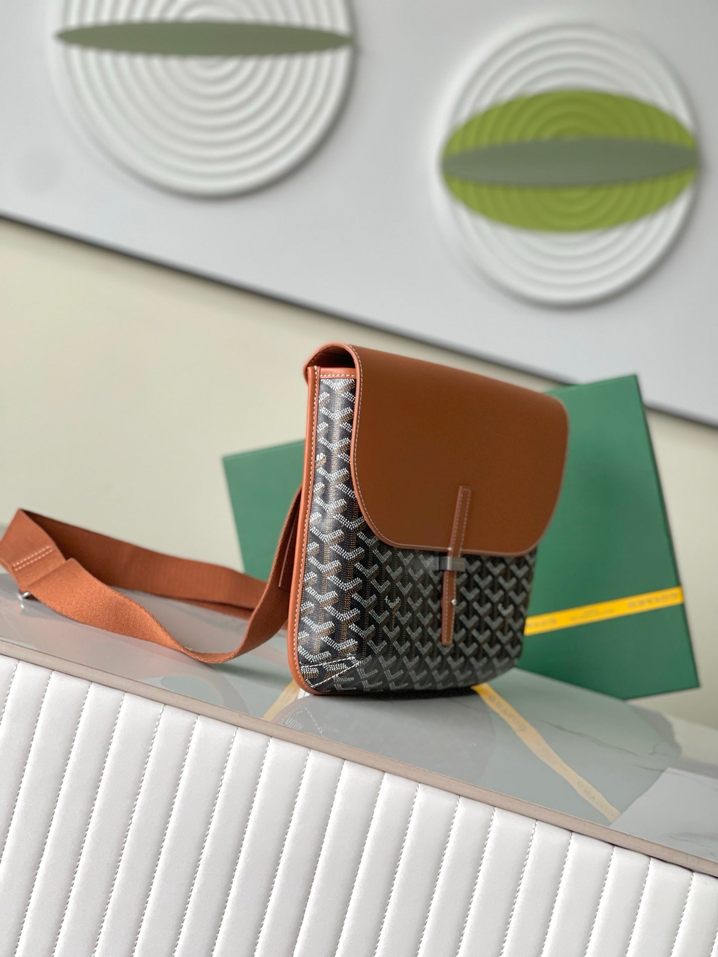 Mini patterned crossbody bag with tan top flap, side pocket, and shoulder strap