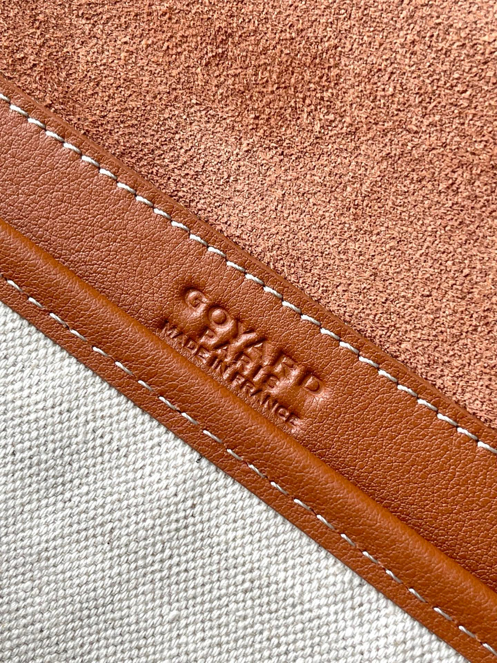 Tan leather trim with stitched edge and stamped GOYARD lettering