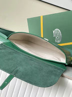Goyard green monogram bag open with beige interior and wide flap