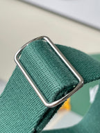 Green fabric strap end with metal buckle hardware