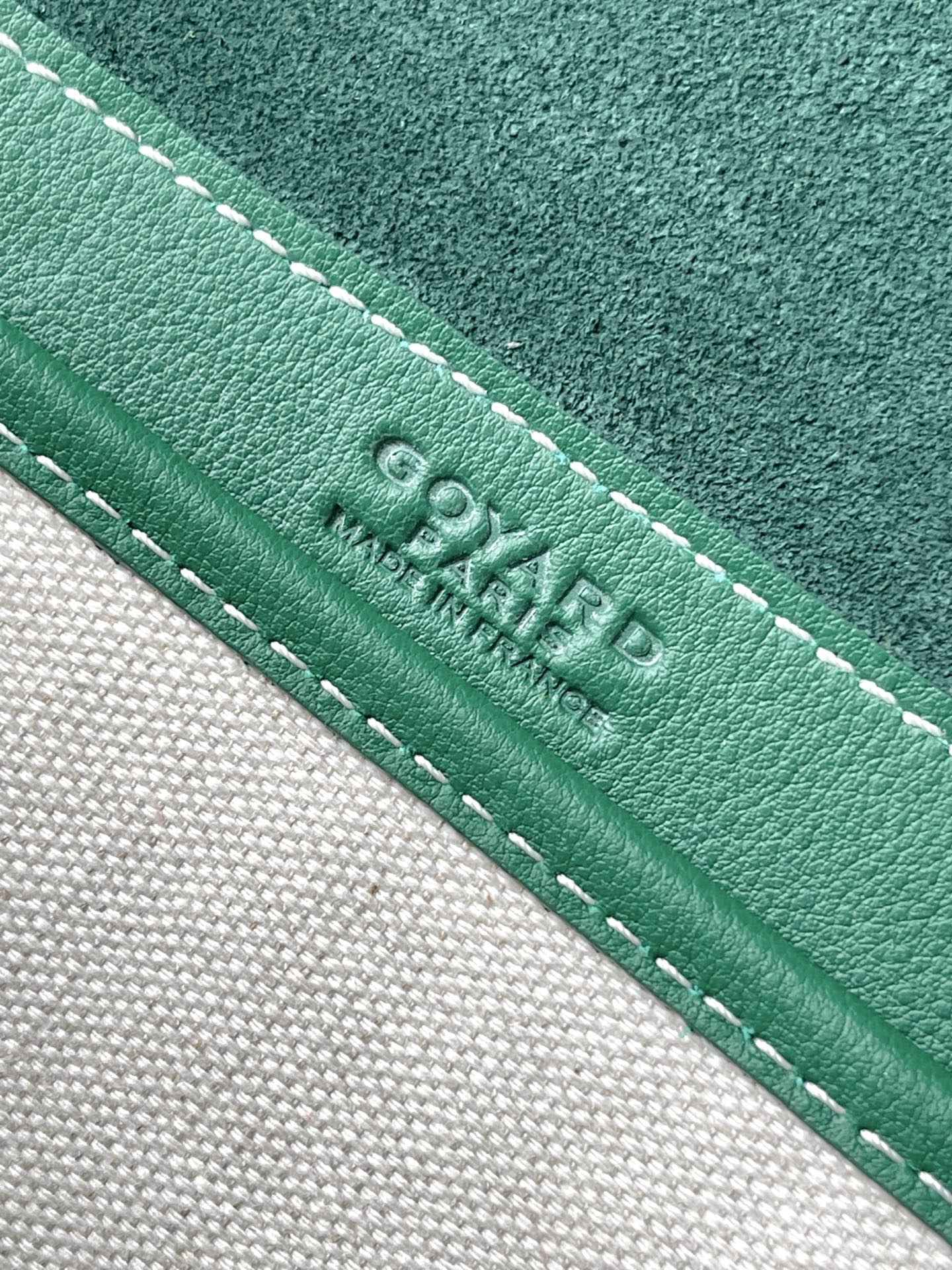 Green leather trim with white stitching and embossed Goyard text