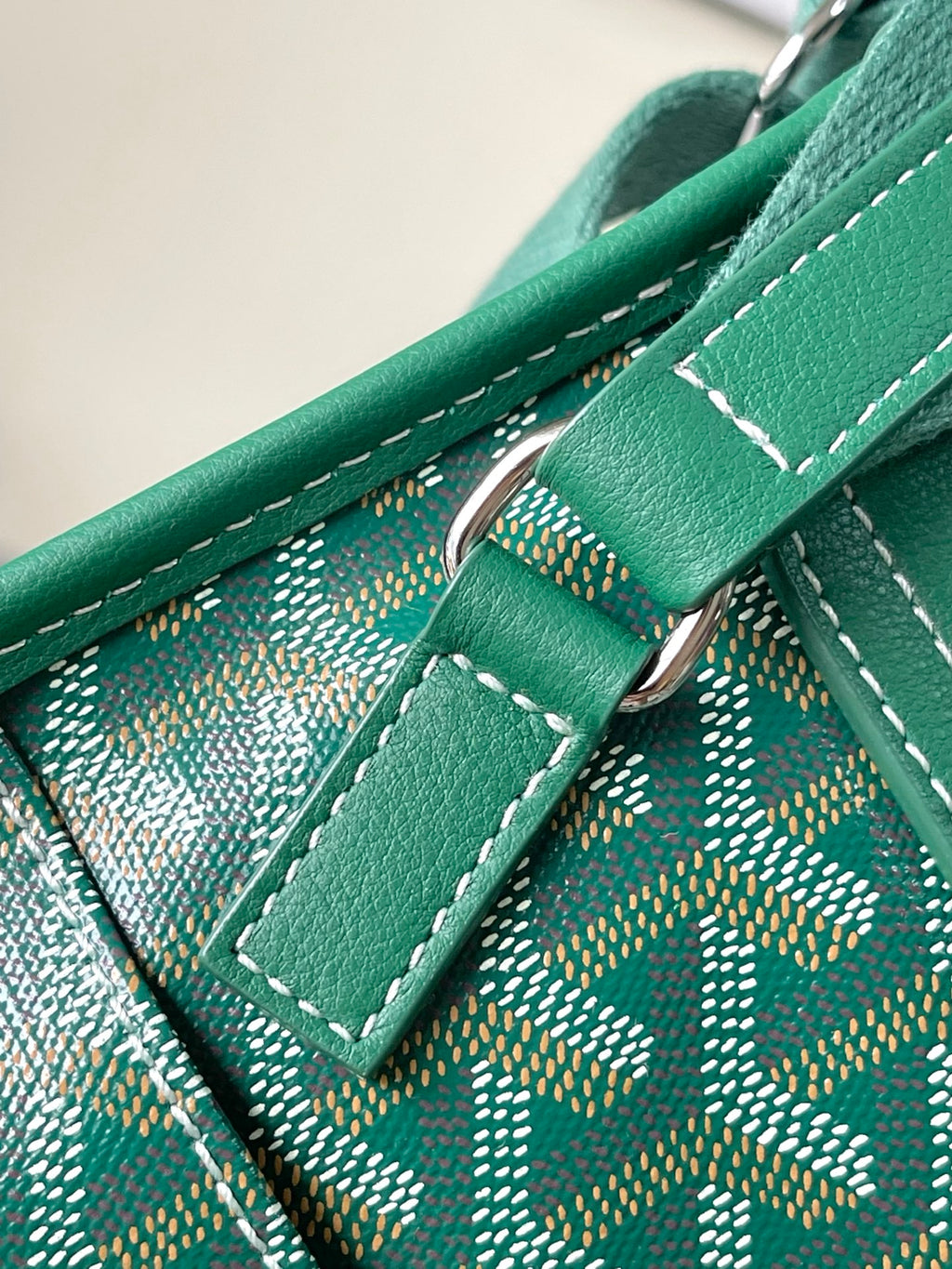 Green leather strap and ring hardware with stitched monogram panel