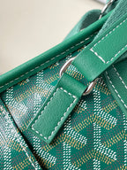 Green leather strap and ring hardware with stitched monogram panel