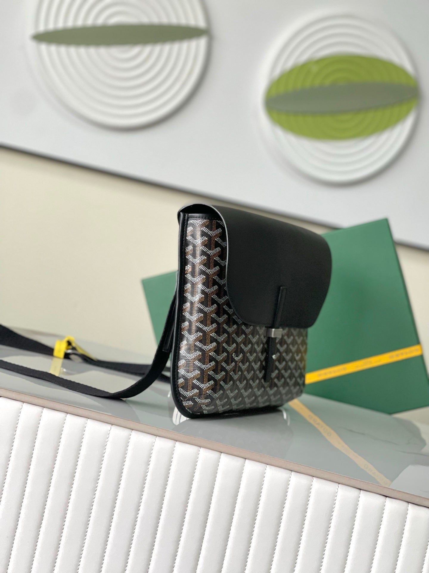 Goyard crossbody bag angled view with top handle and adjustable strap