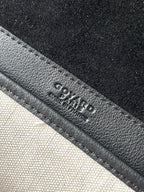 Goyard logo embossed on dark leather strap