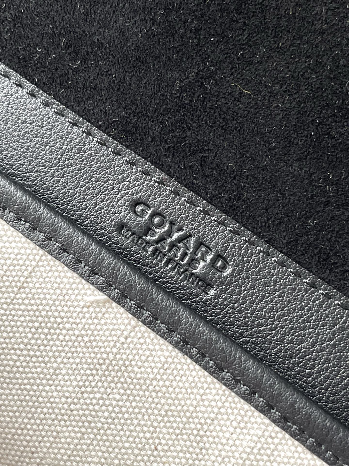 Goyard logo embossed on dark leather strap