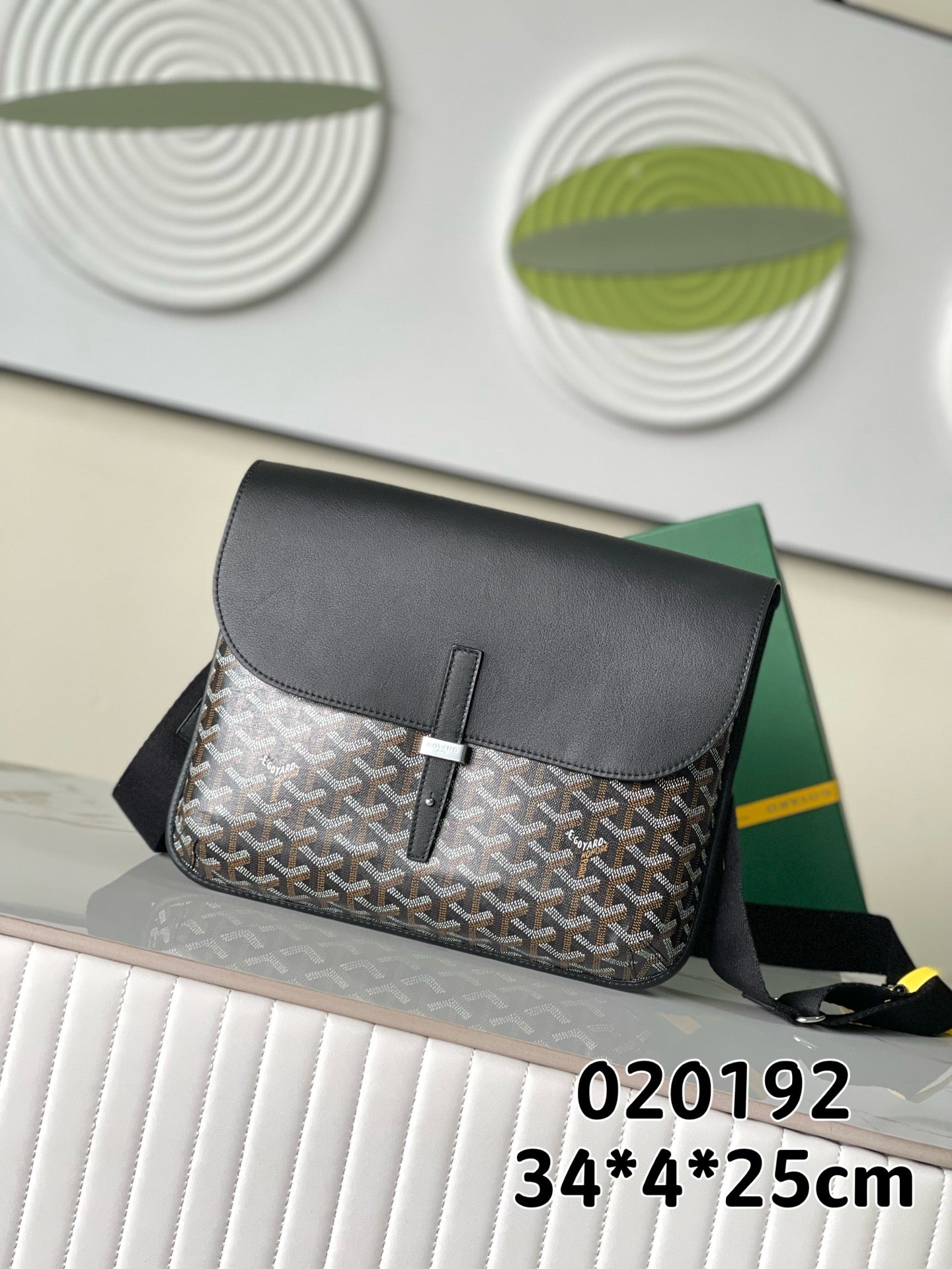 Goyard crossbody bag with front flap, dark leather trim, patterned monogram canvas