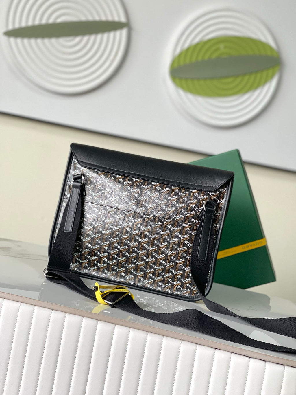 Goyard handbag open, showing patterned lining and zippered side pockets