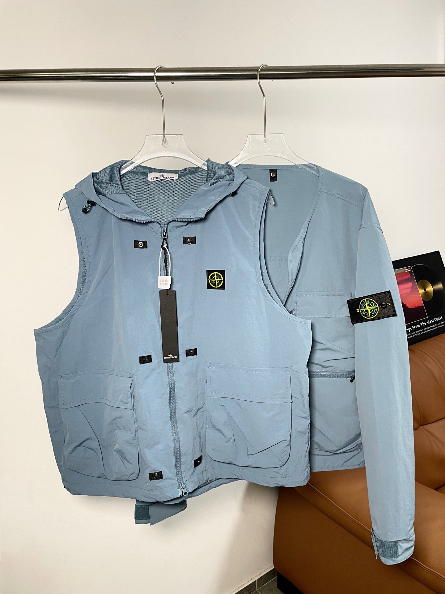 Light blue Stone Island hooded zip vest with logo patch and front pockets