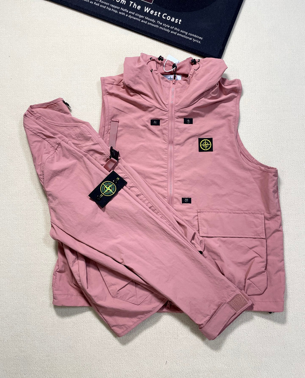 Rose pink Stone Island hooded zip vest with front pockets and logo patch