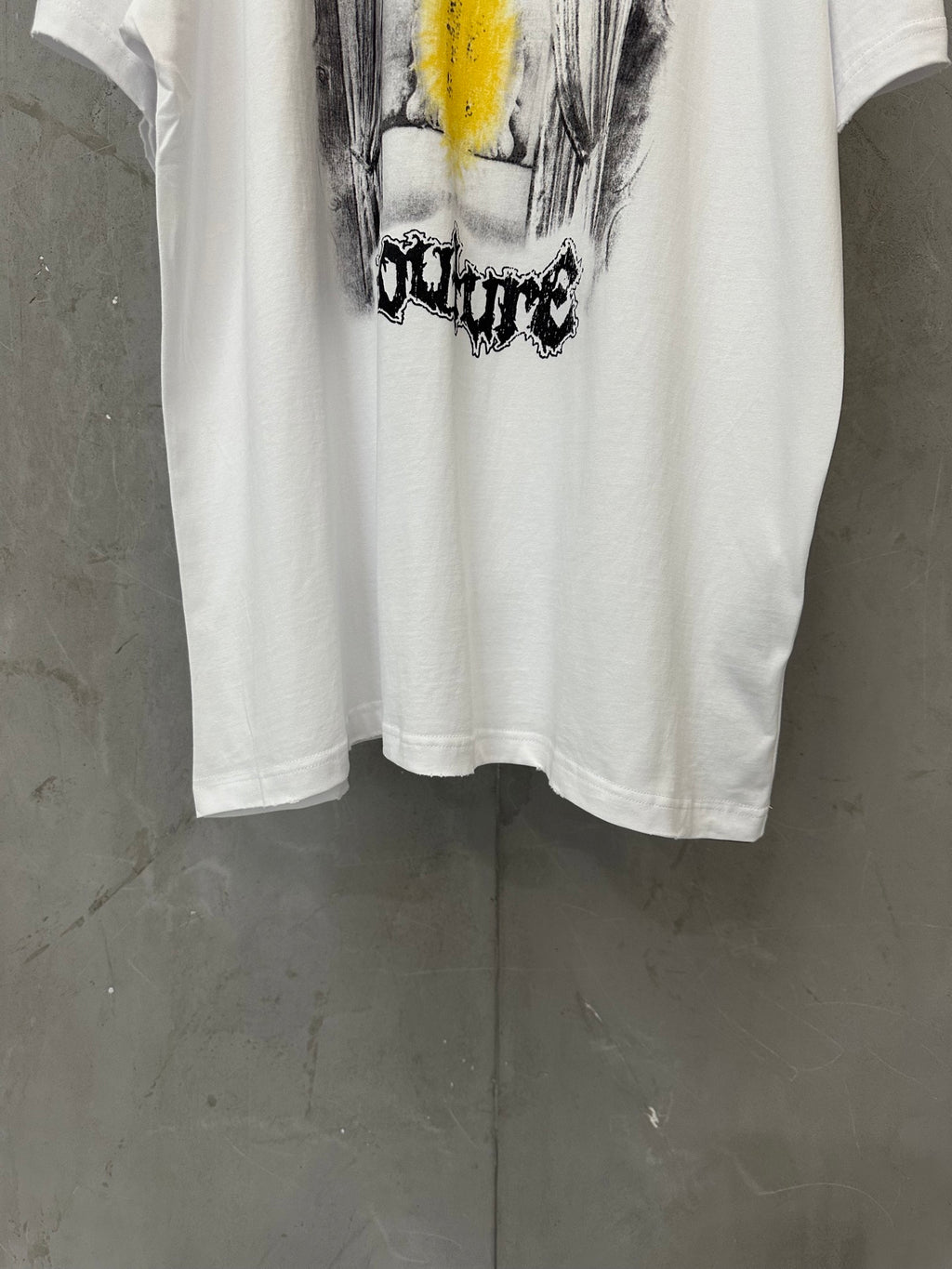 White graphic T-shirt with large front print in black and yellow