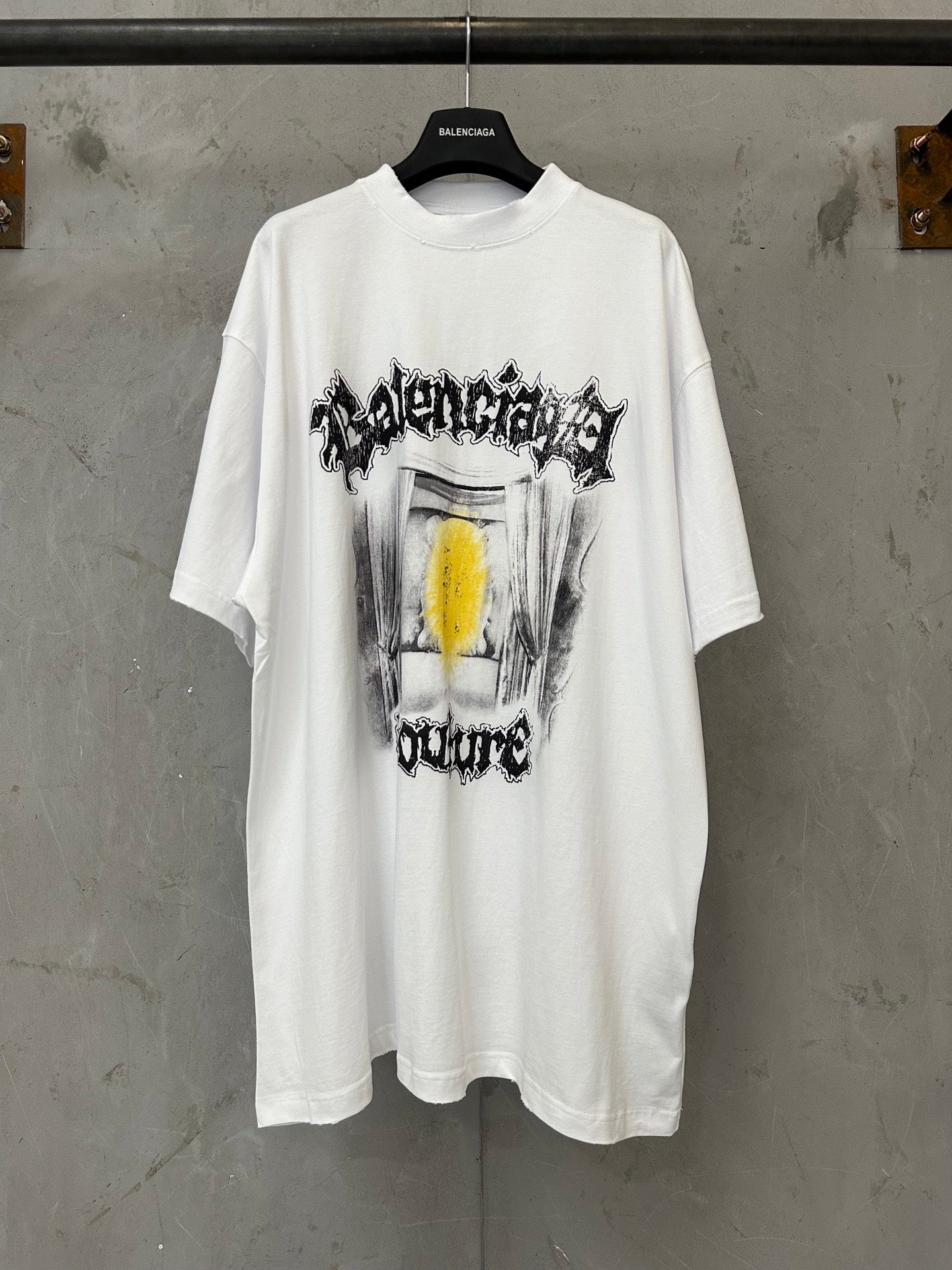 Balenciaga white graphic T-shirt with front drum-style print and yellow accent
