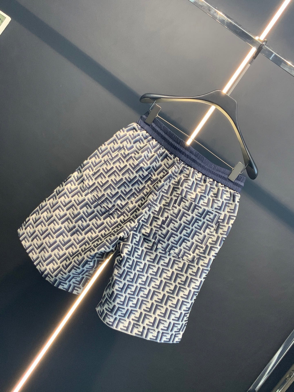 Dior pants angled close-up with navy elastic waistband and FF all-over print