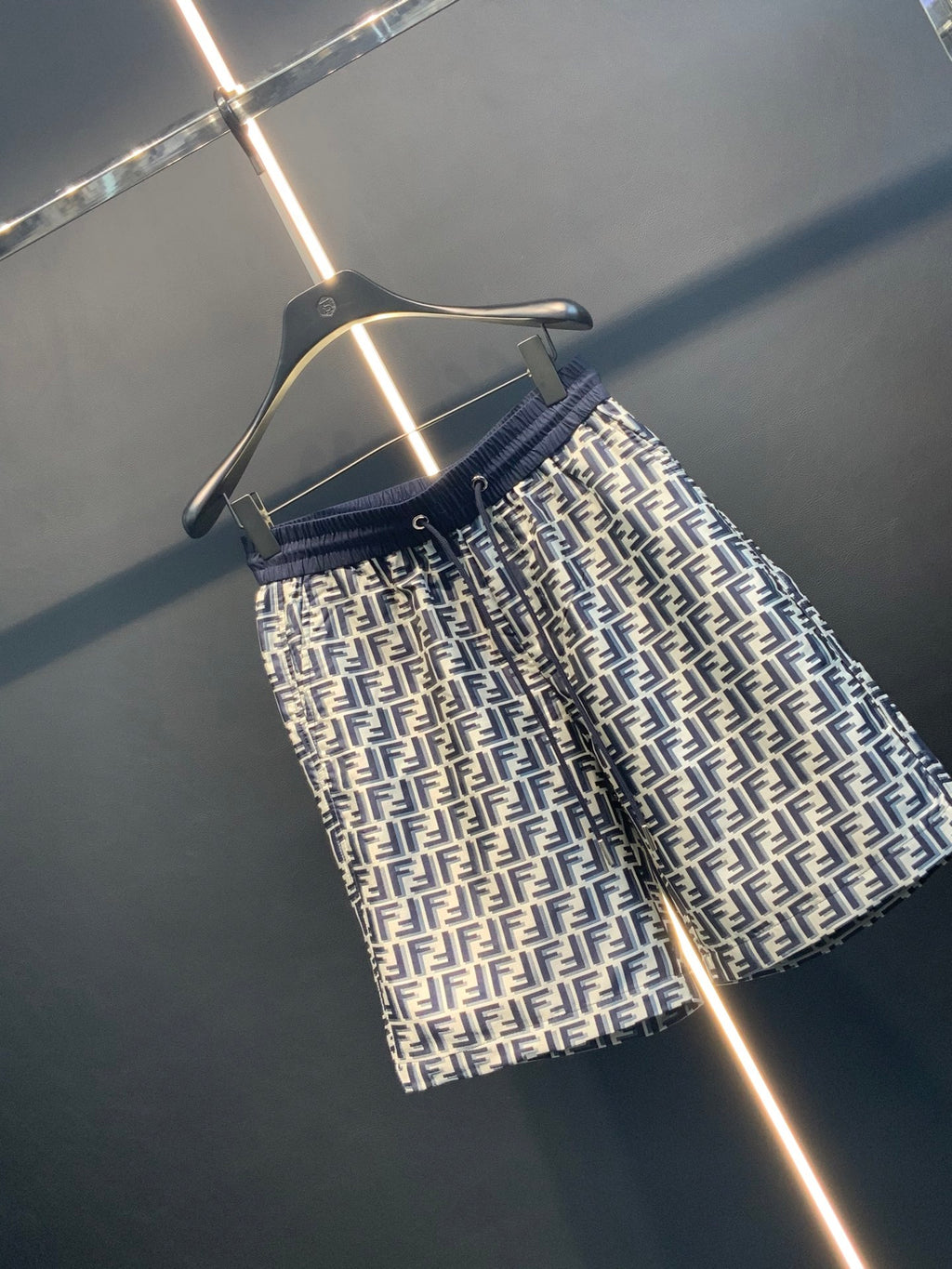 Dior pants angled view with navy elastic waistband and all-over FF pattern