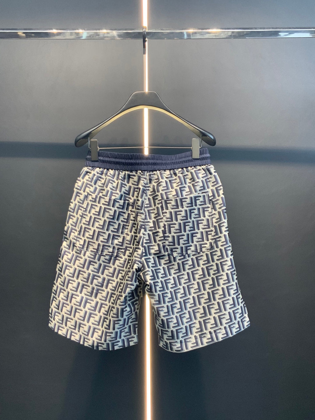 Dior pants straight-on view with navy elastic waistband and repeating FF print