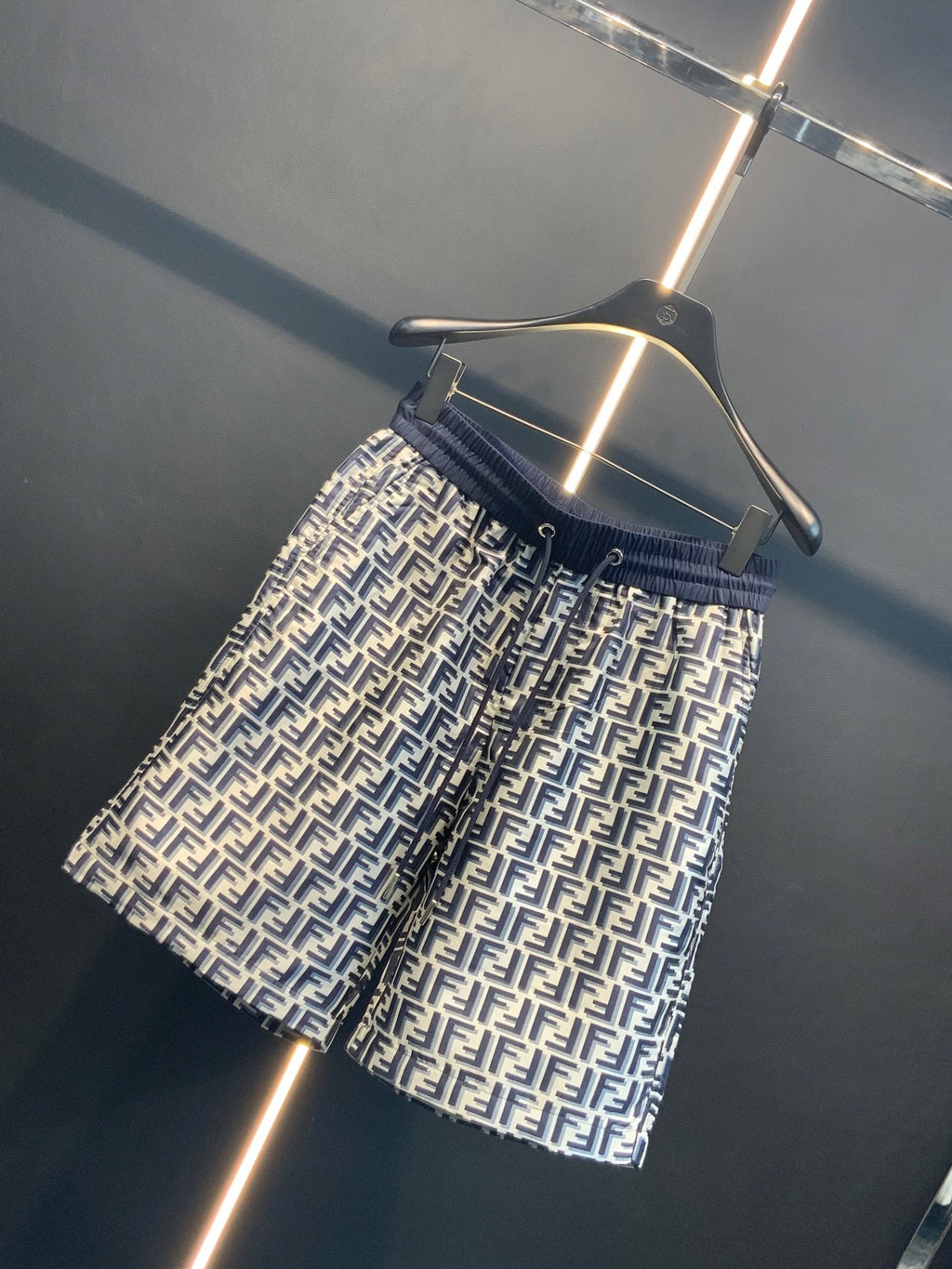 Dior pants side view showing navy waistband and repeating FF print