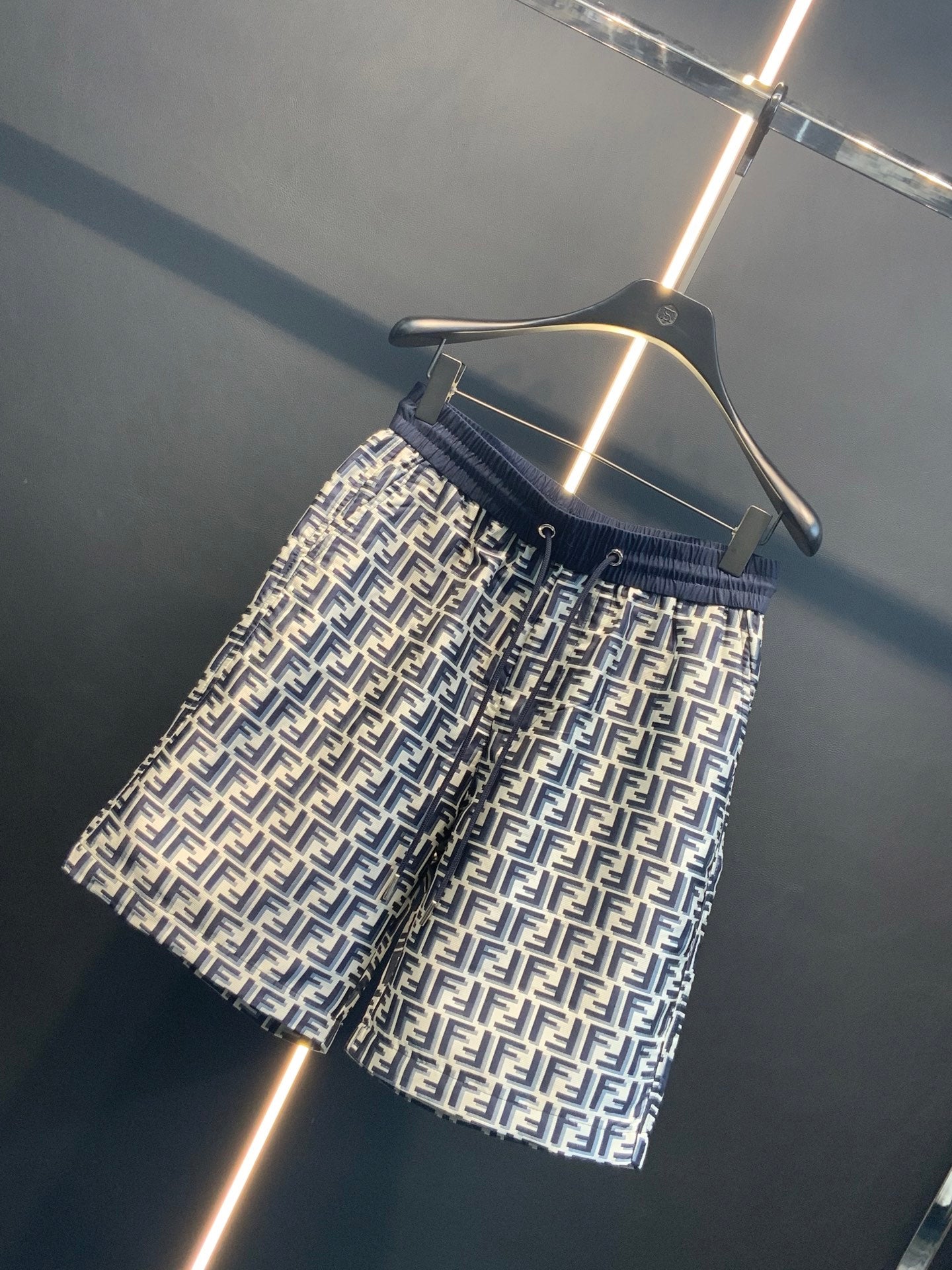 Dior pants side view showing navy waistband and repeating FF print