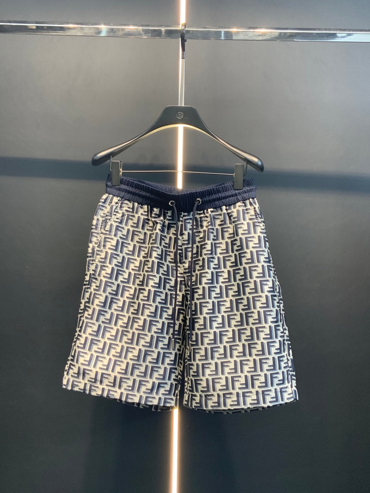 Dior pants front view with navy elastic waistband and repeating FF print