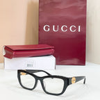 Black rectangular sunglasses with clear lenses and gold logo detail