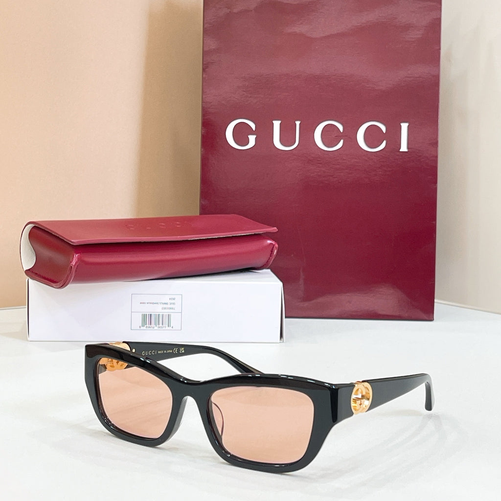 Black rectangular sunglasses with tan lenses and gold logo detail