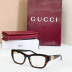 Tortoiseshell rectangular sunglasses with brown lenses and gold logo detail