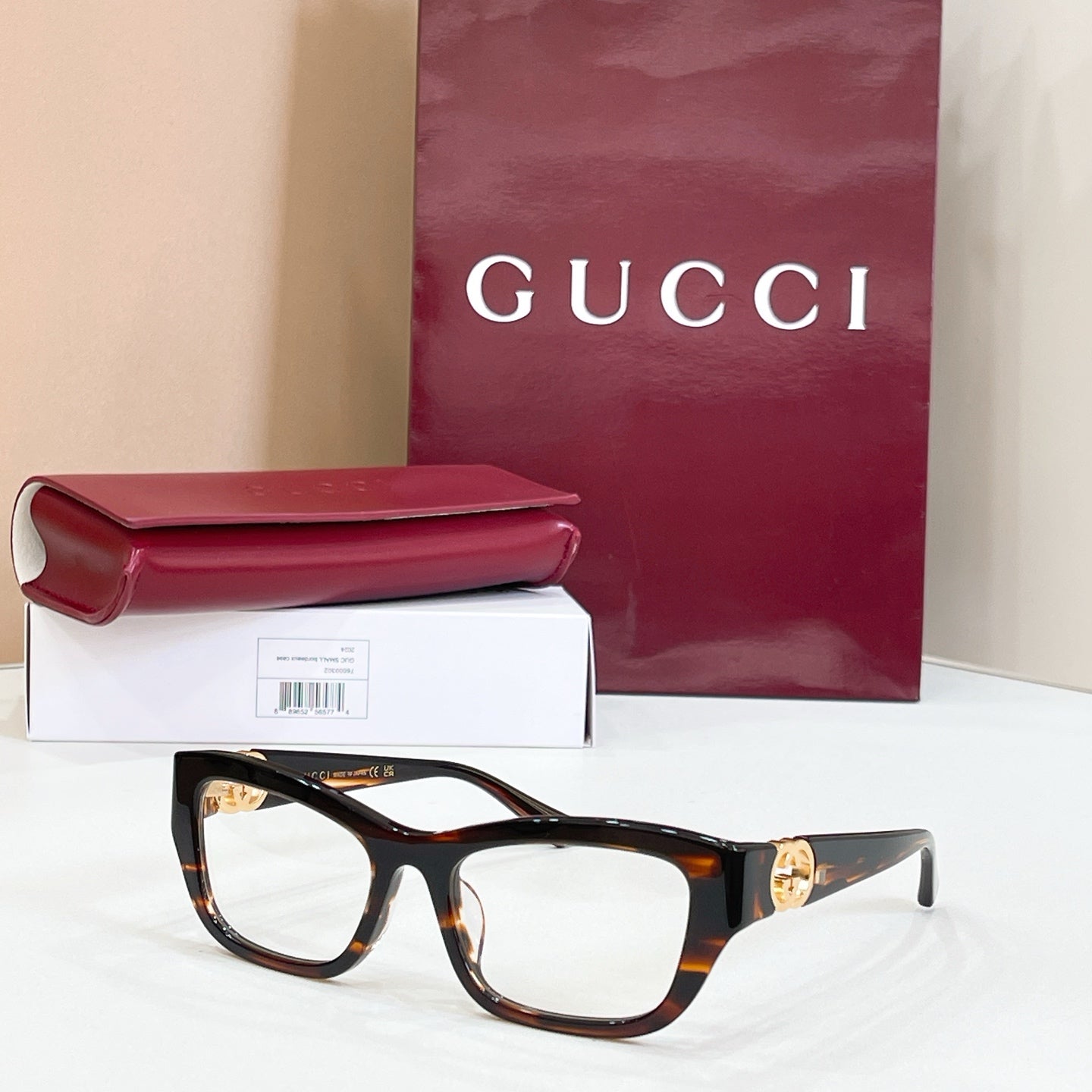 Tortoiseshell rectangular sunglasses with brown lenses and gold logo detail