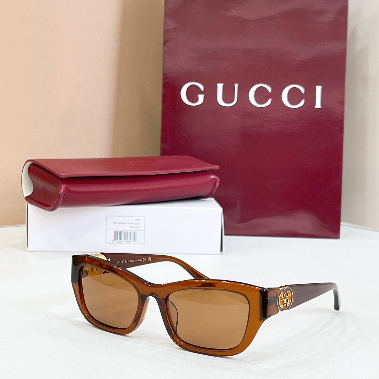 Tortoiseshell rectangular sunglasses with amber lenses and gold logo detail